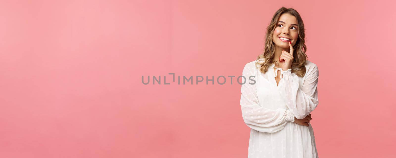 Beauty, fashion and women concept. Portrait of feminine, beautiful blond girl in white dress, imaging something romantic and interesting, smiling look up thoughtful, have plan, make decision.