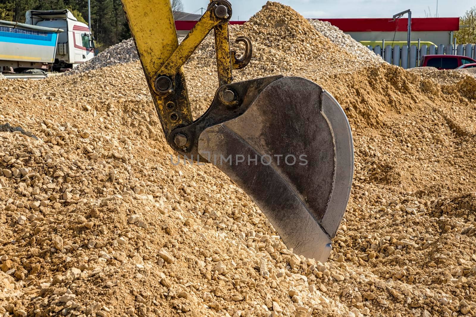 Industrial background. Digger bucket close-up. Construction excavator bucket. by EdVal