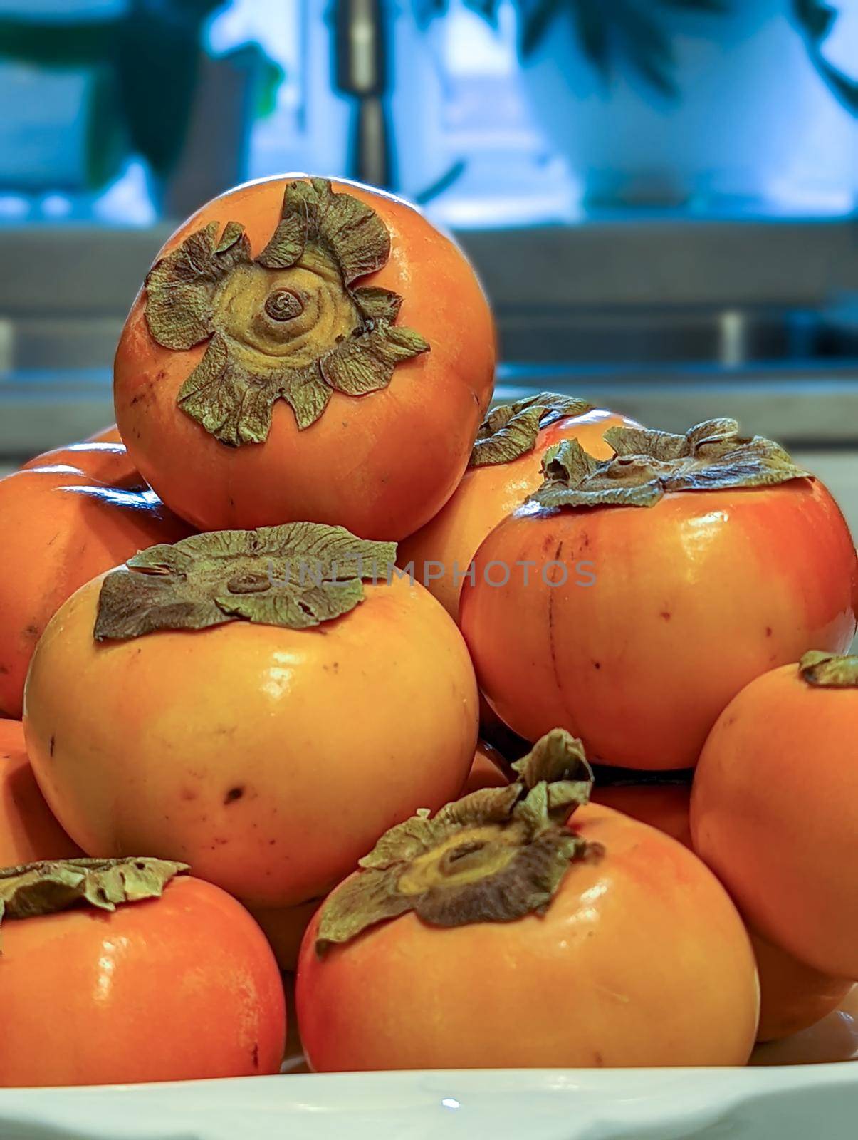 fresh persimmons on a kitchen table 