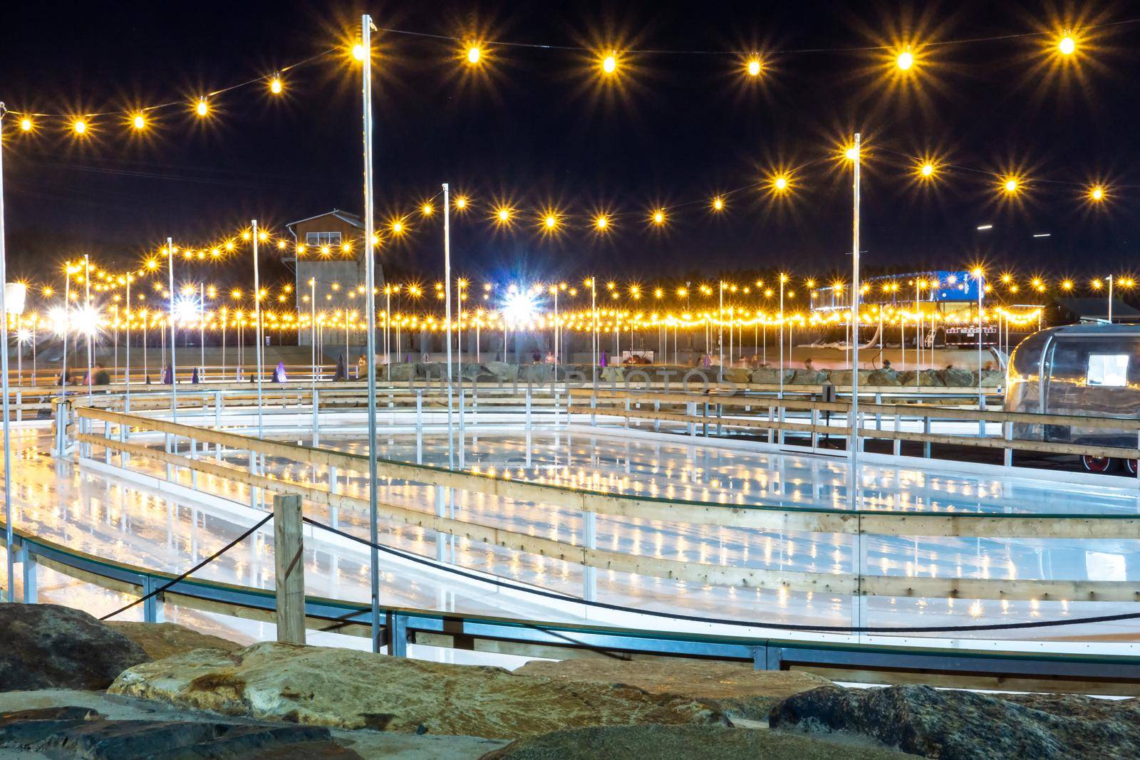 beautiful outdoor ice rink at night with lights by digidreamgrafix