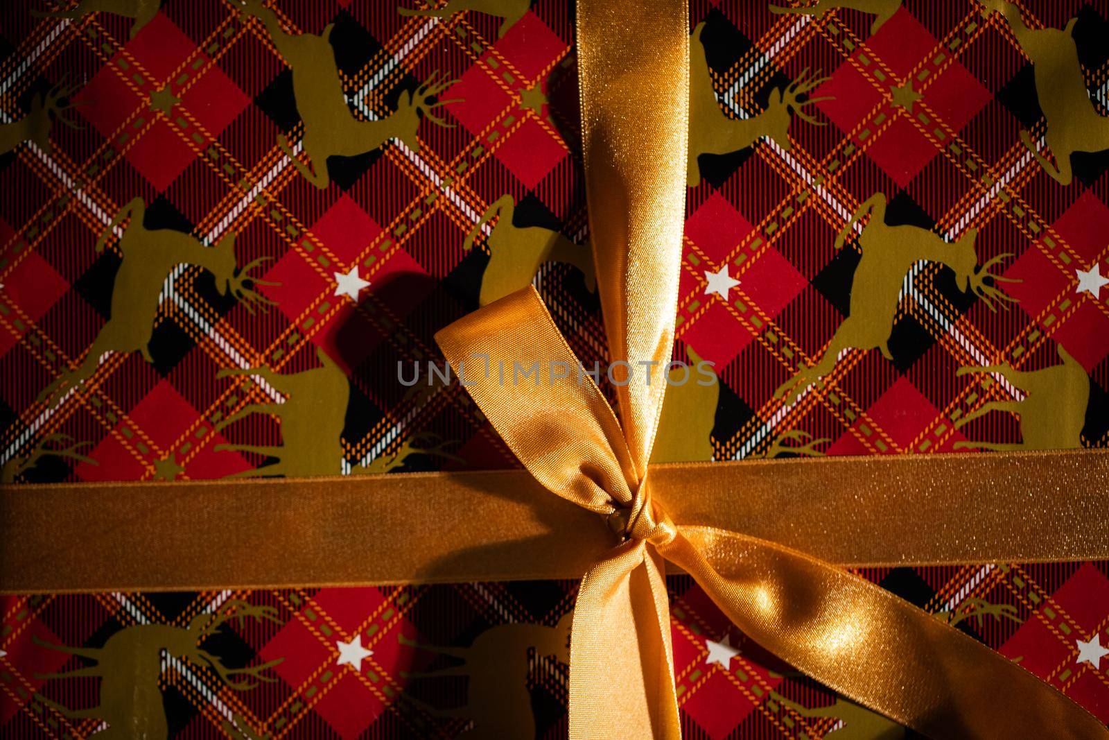 Prepared for giving a gift with a beautiful golden bow for a husband or wife on Christmas Day. Gift wrapped.