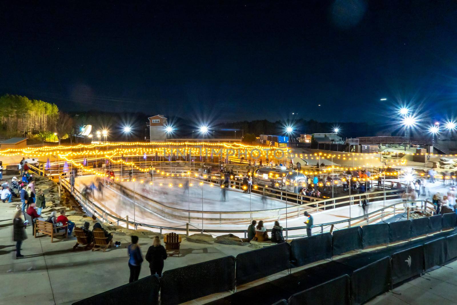 beautiful outdoor ice rink at night with lights by digidreamgrafix