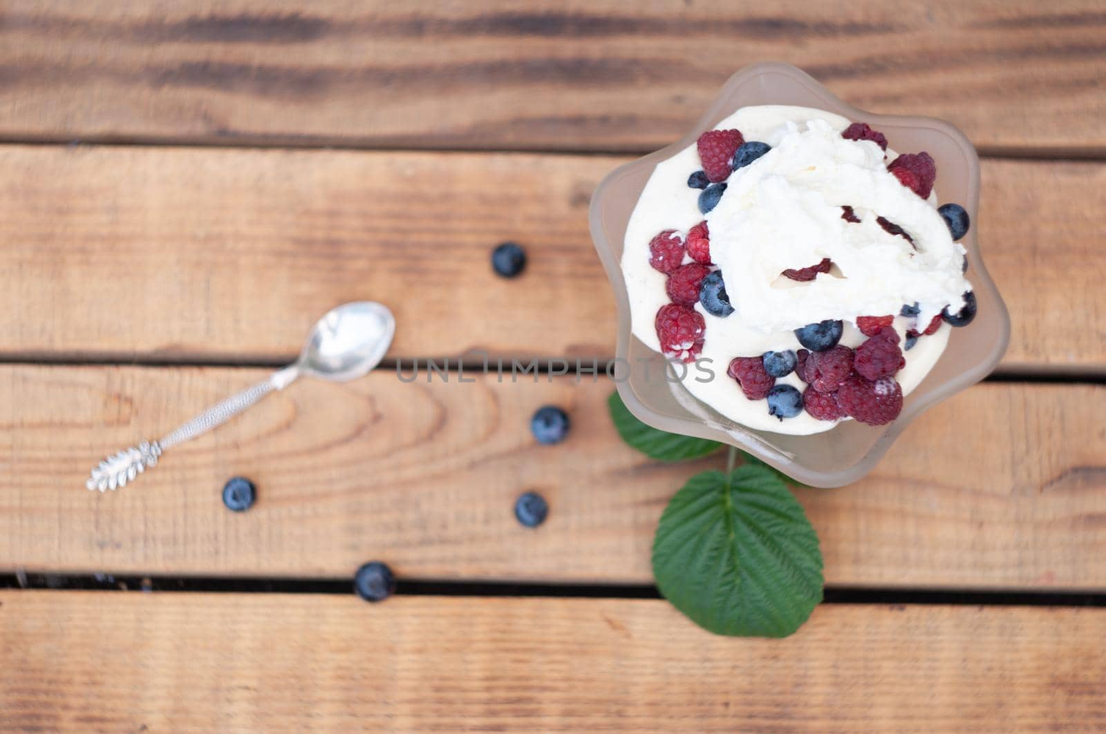 Vanilla ice cream with fresh berries and whipped cream, summer dessert with natural vitamins. High quality photo