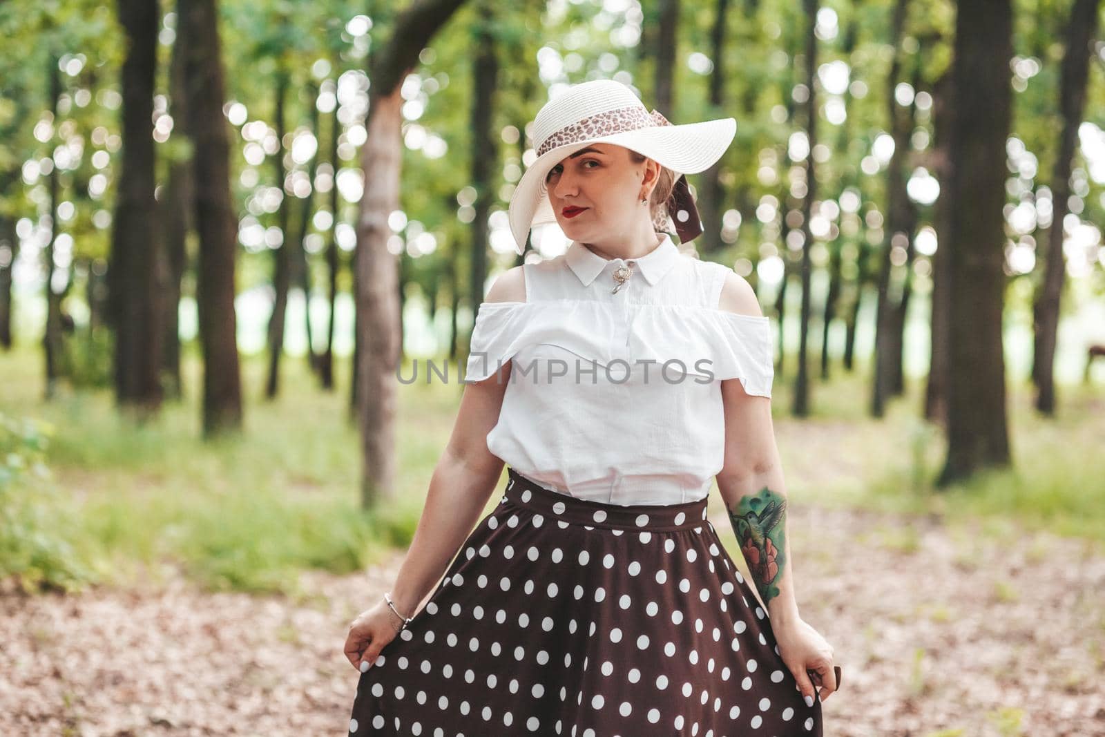 young girl covered her face with a hat, in the woods by mosfet_ua