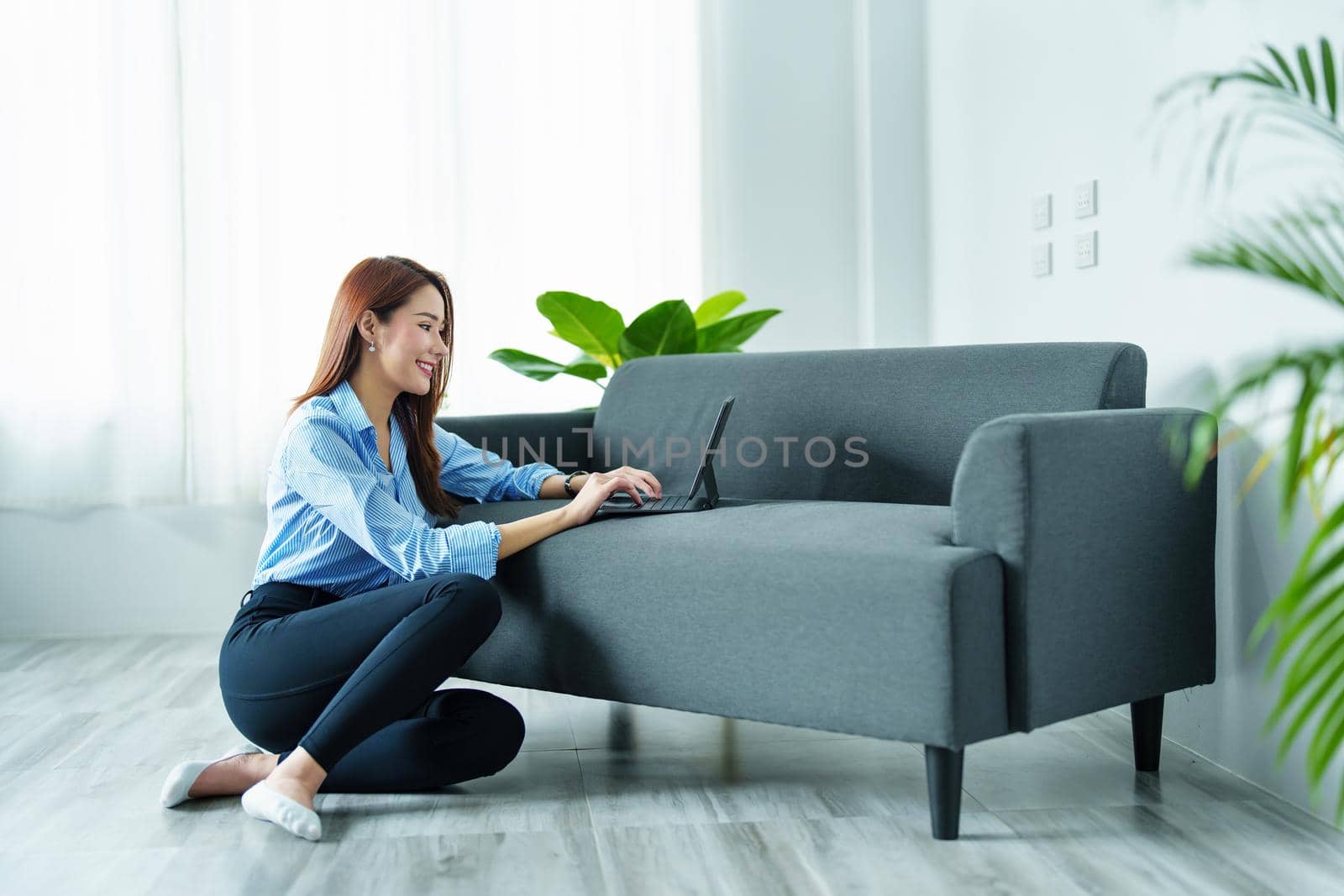 internet learning, online shopping, selling, meeting, information searching, Portrait of young Asian woman showing smiling face while using tablet to work at home. by Manastrong