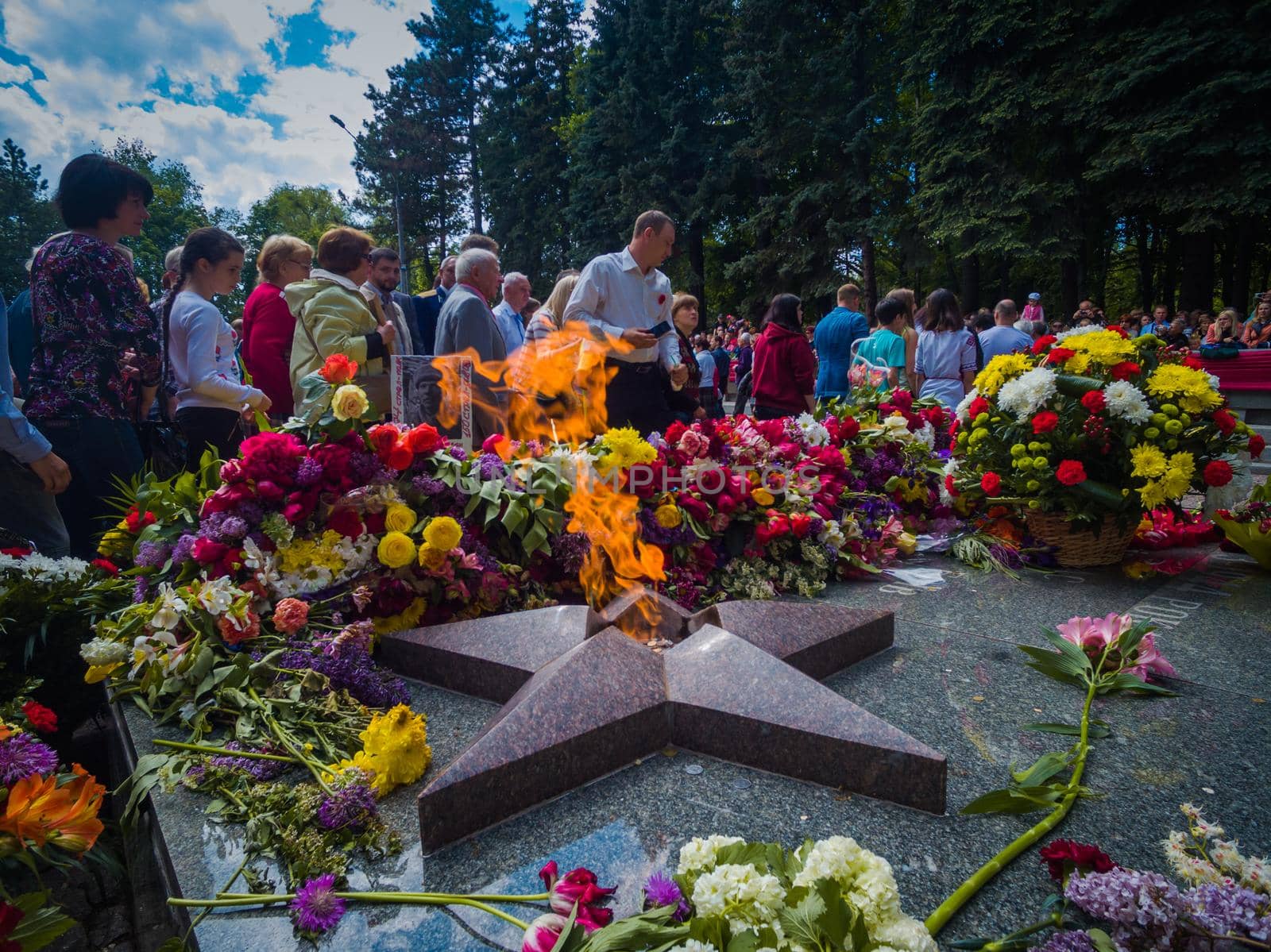Kryvyi Rih, Ukraine - 05.09.2021 : Unidentified veterans lay flowers at Victory Monument during the celebration of Victory Day on May 9, by mosfet_ua