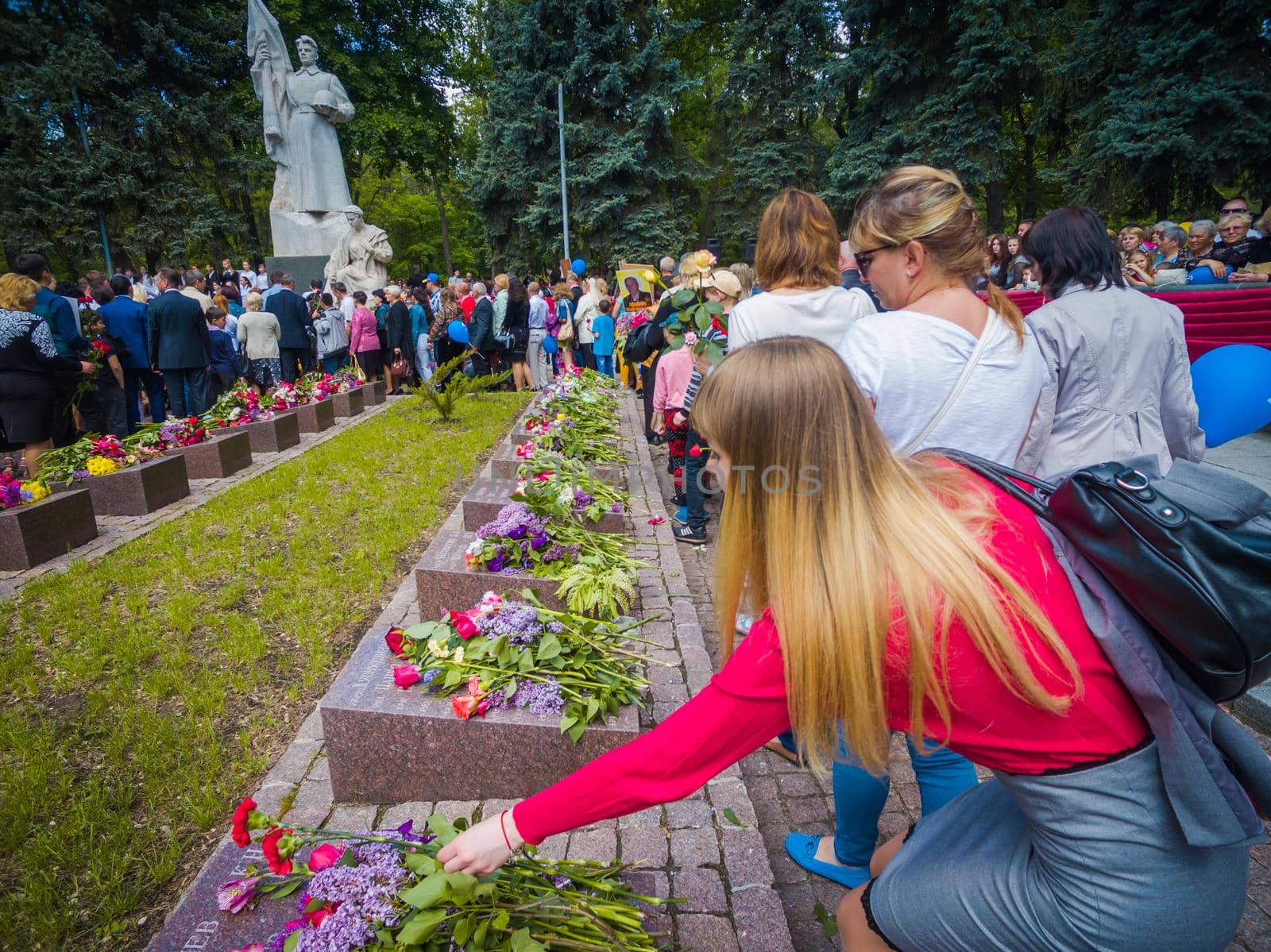 Kryvyi Rih, Ukraine - 05.09.2021 : Unidentified veterans lay flowers at Victory Monument during the celebration of Victory Day on May 9, by mosfet_ua