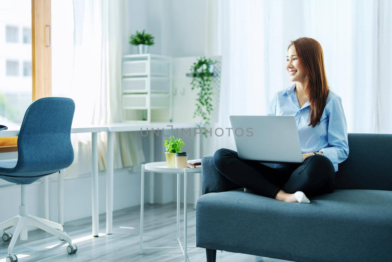 internet learning, online shopping, selling, meeting, information searching, Portrait of young Asian woman showing smiling face while using tablet to work at home