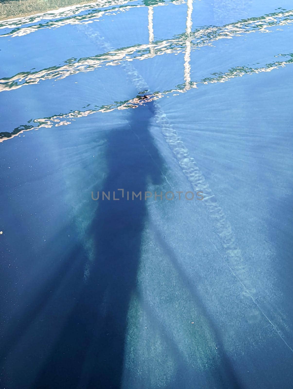 shadow of a person in pool of water