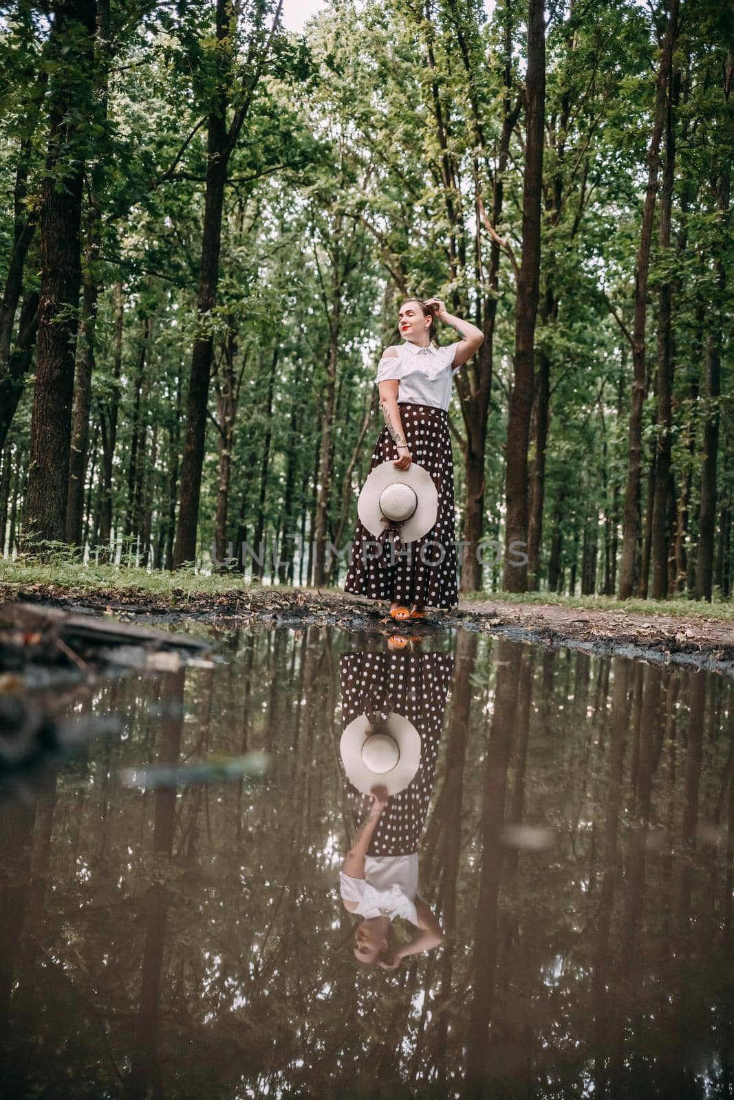photo of a girl in the reflection of a puddle, in the forest by mosfet_ua