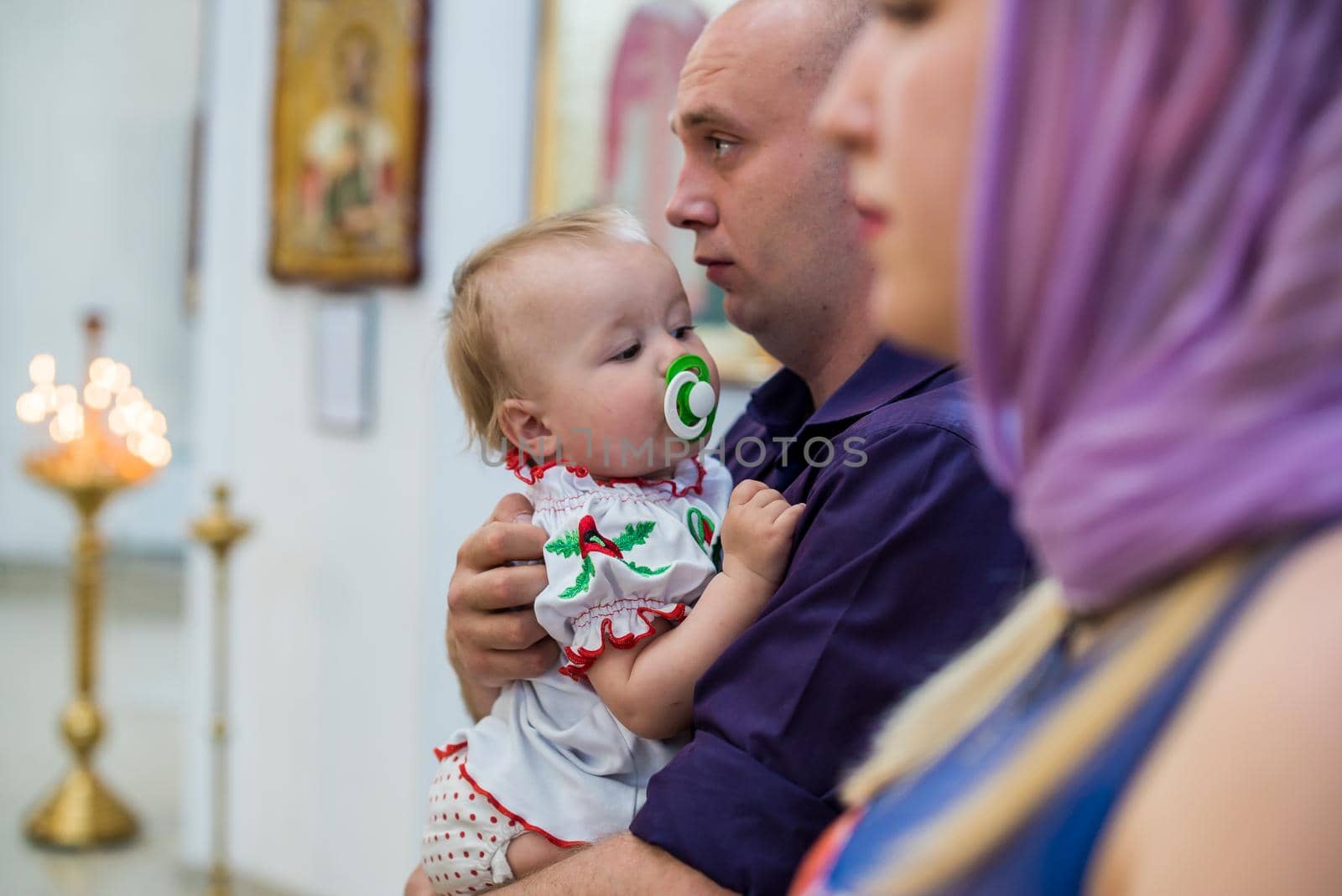 The sacrament of baptism. Newborn baby during christening and chrismation