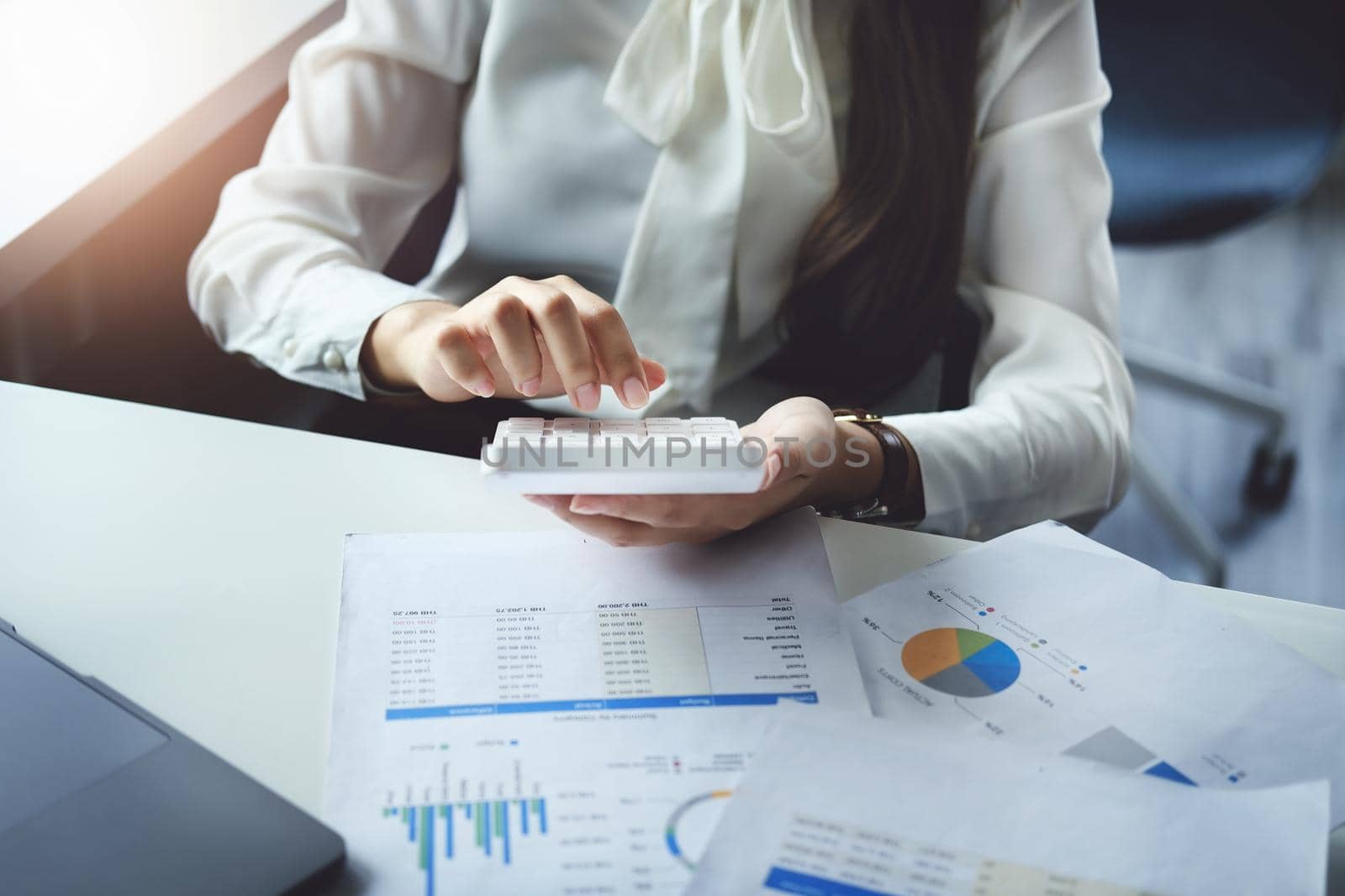 accountant, Auditor, Self-Employed, Finance and Investment, tax calculation and budget, Asian female entrepreneur using a calculator to calculate. Company business results document