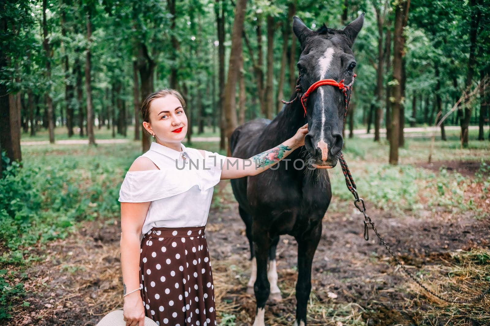 photo of a young smiling blonde, in a white blouse and skirt, with a horse, in a summer forest by mosfet_ua