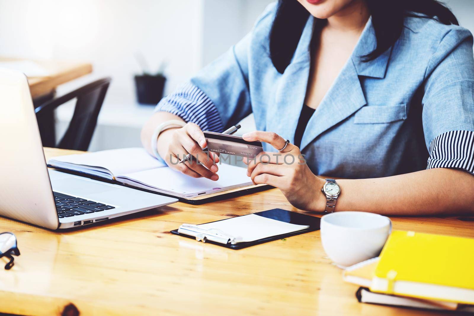 Online Shopping and Internet Payments, Asian woman are using their credit cards and to computer laptop for shop online or conduct errands in the digital world