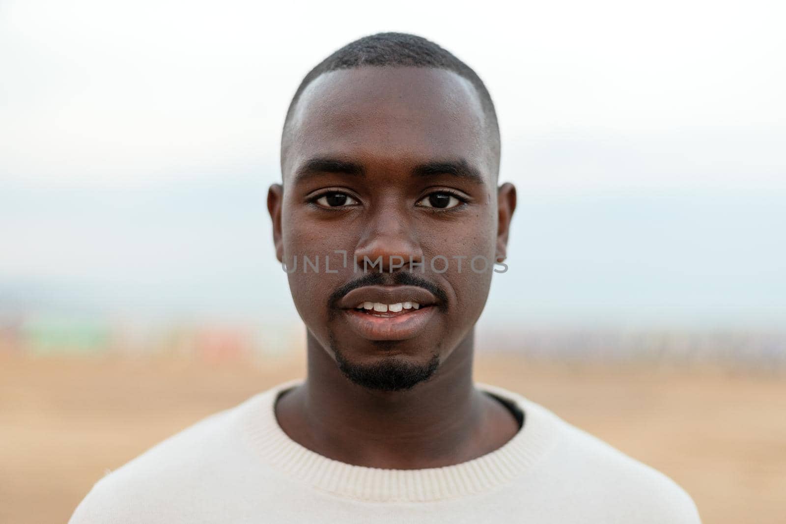 Portrait of young African American man looking at camera. Headshot. by Hoverstock