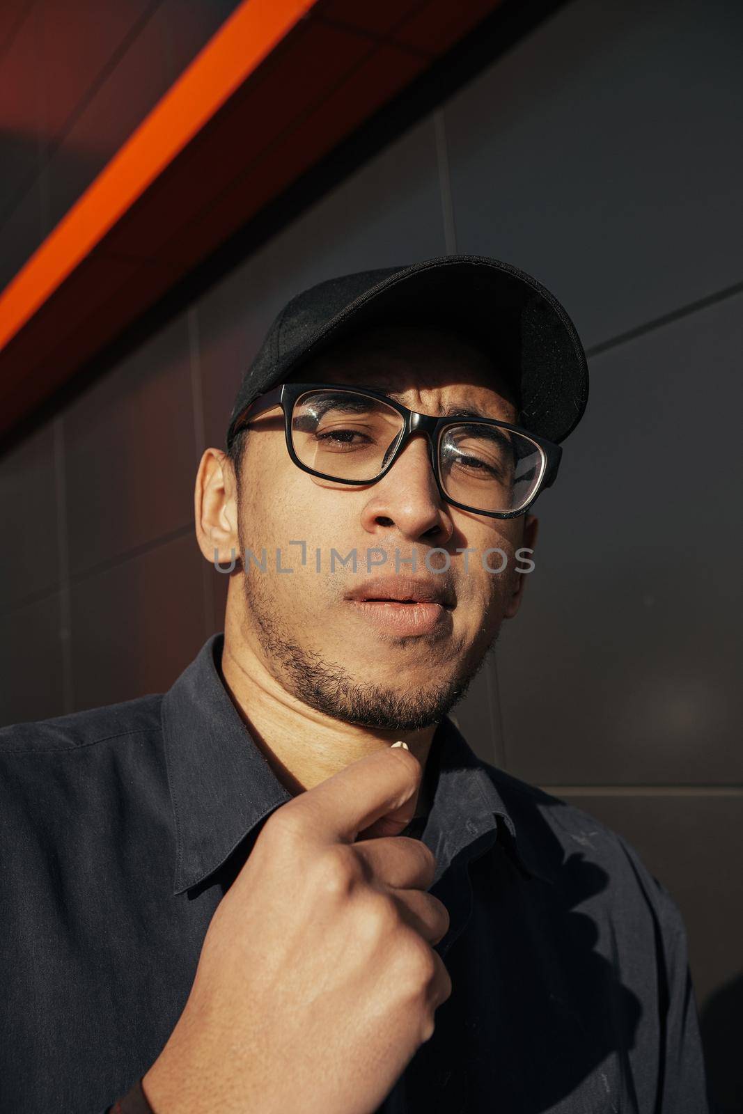 Young african american man holding peanuts on black background street