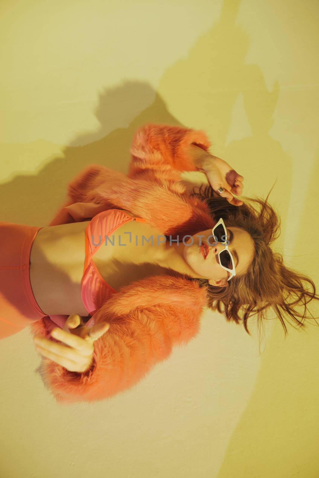 Fashion model in pink suit. Studio shot.