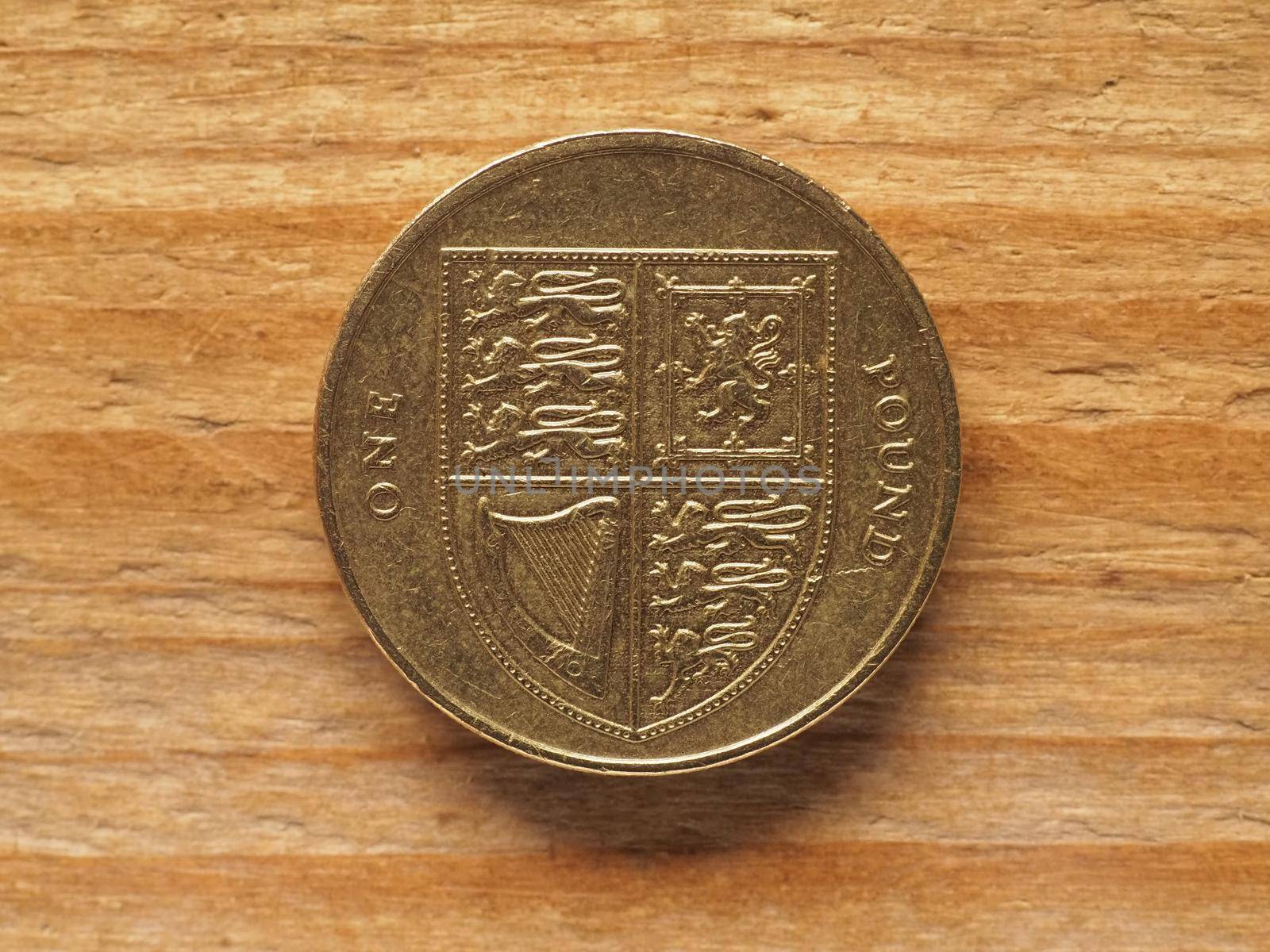 one pound coin reverse side showing shield of the royal arms representing UK, currency of the United Kingdom