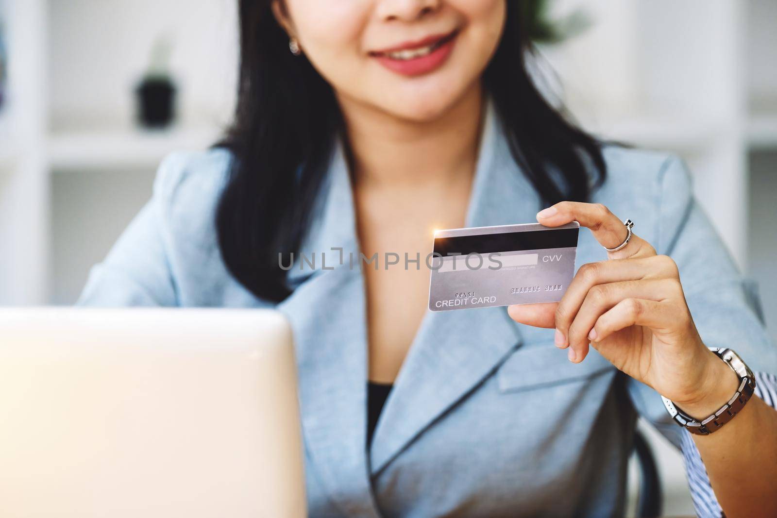 Online Shopping and Internet Payments, Asian woman are using their credit cards and laptop computer to shop online or conduct errands in the digital world