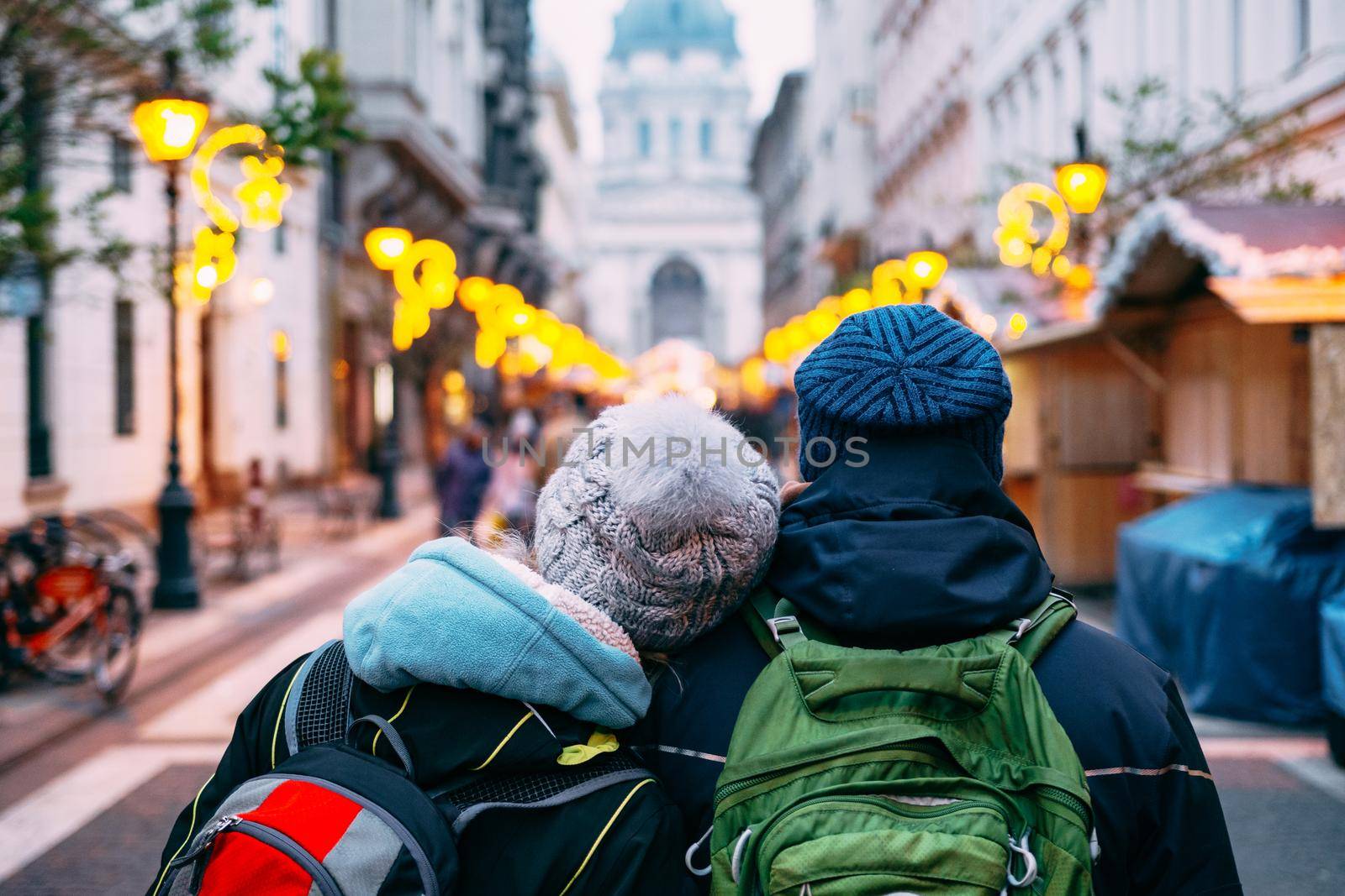 A couple of tourists in love walks around Budapest against the background of St. Stephen's Basilica. High quality photo