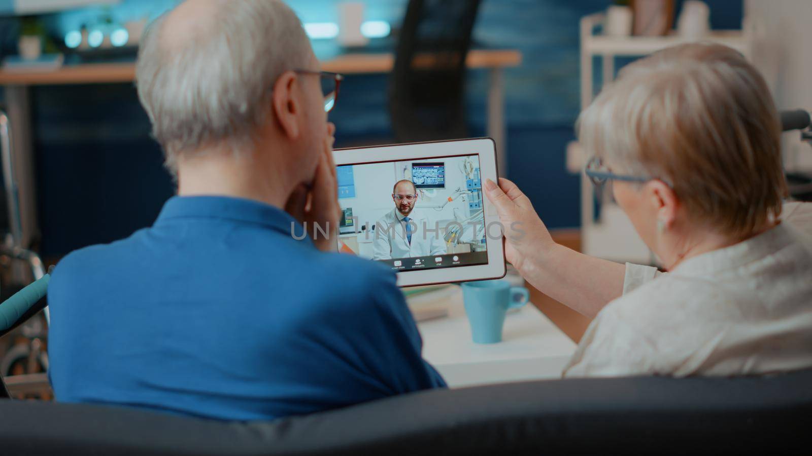 Elder patients with toothache using videocall to talk to dentist by DCStudio