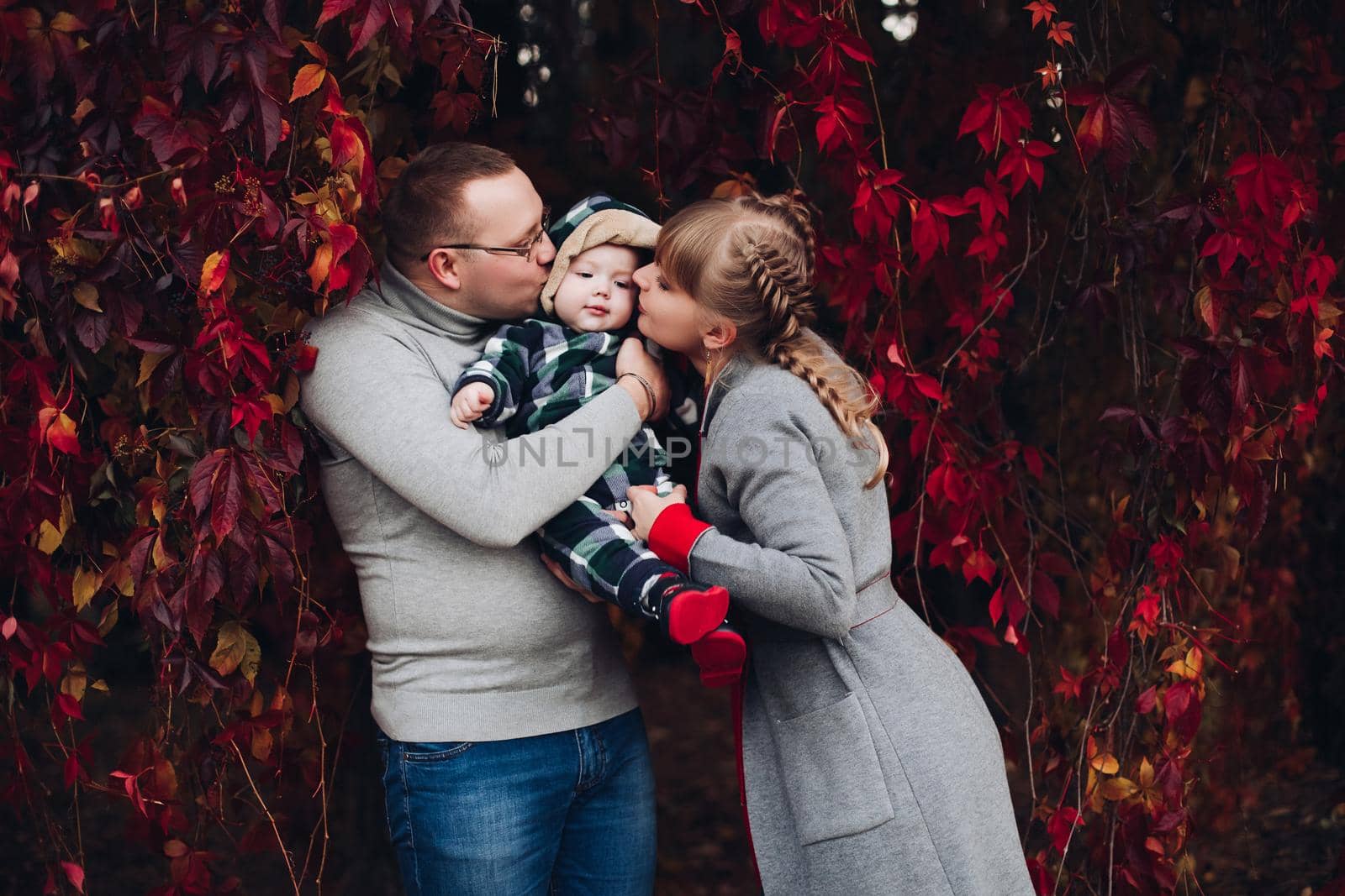 Beautiful and happy family with little child in park. by StudioLucky