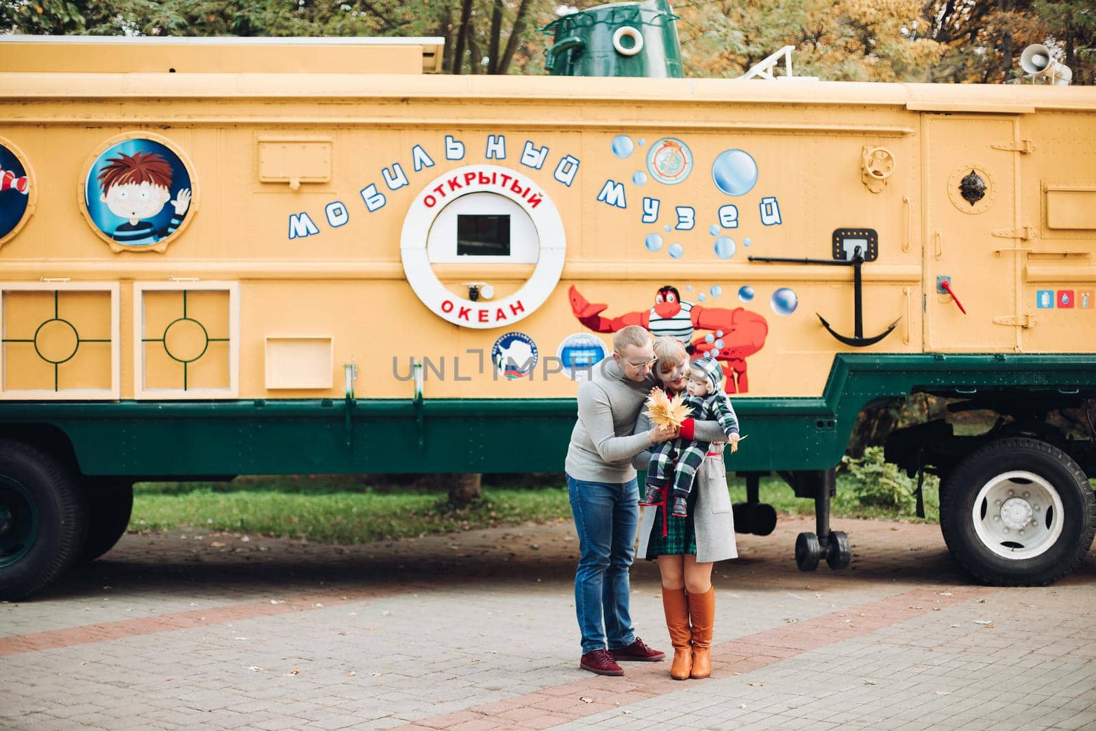 Beautiful and happy family with little child in park. by StudioLucky