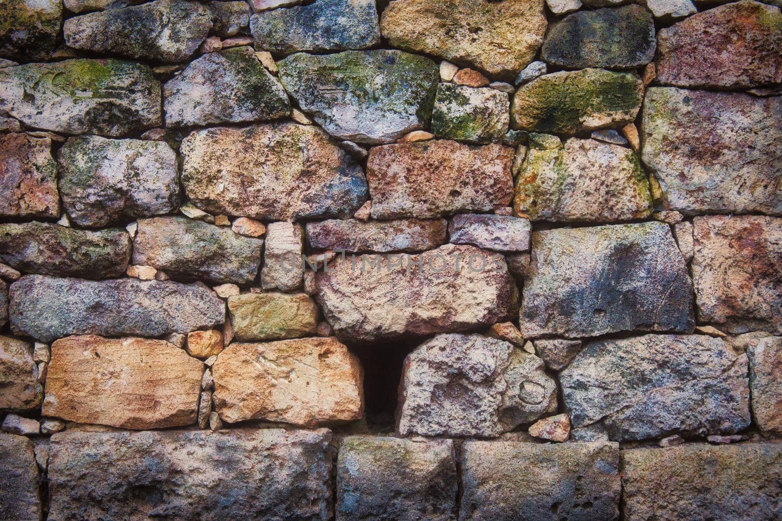Old rustic stone wall with varied colors and sizes and textures by tennesseewitney