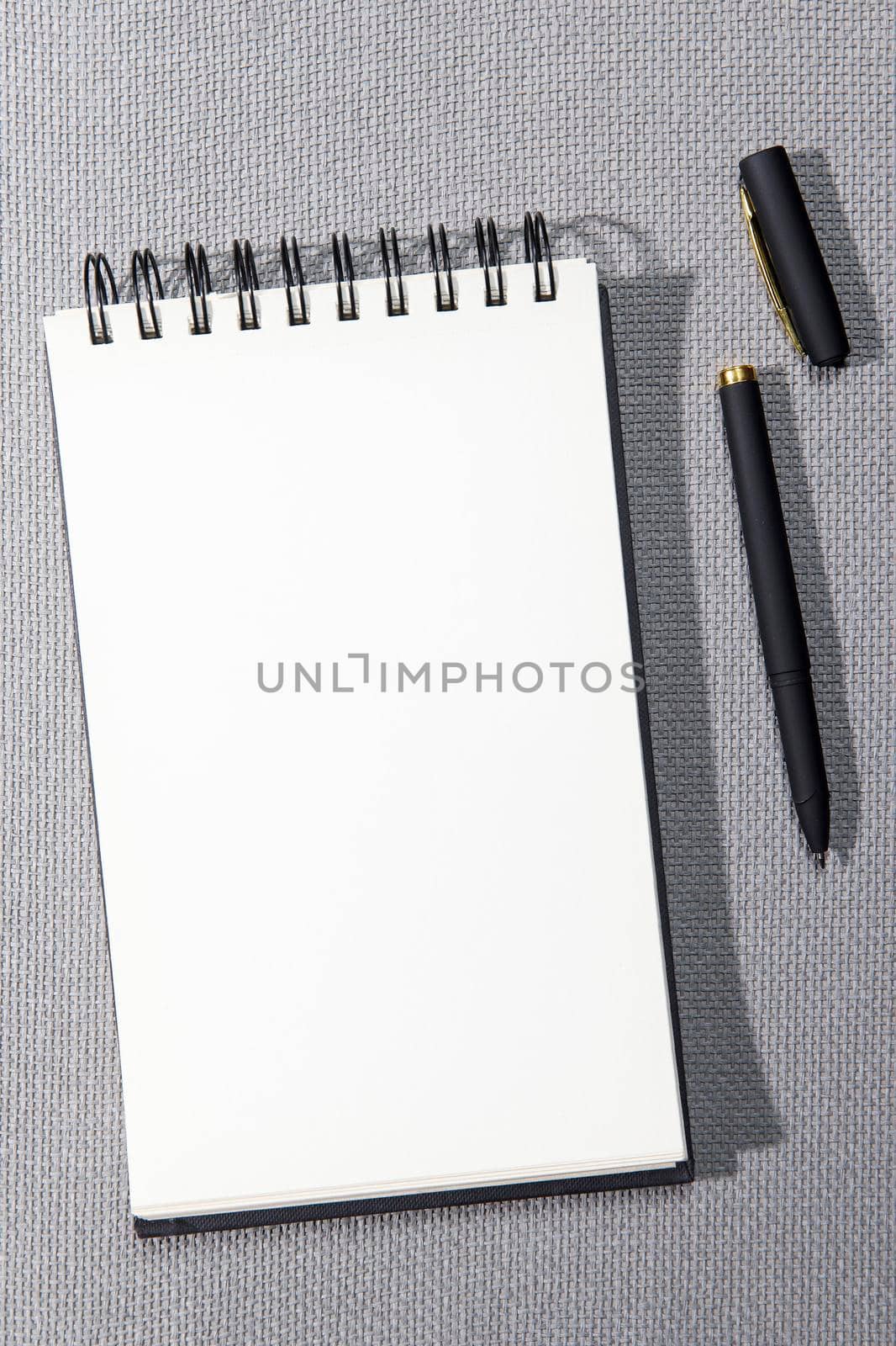 A white springboard for sketching is on a gray canvas texture. Black pen.