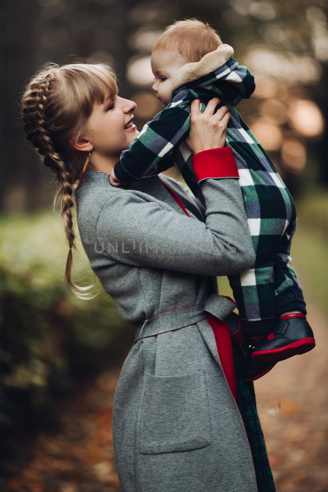 Beautiful caucasian mother with braid embracing her daughter. by StudioLucky