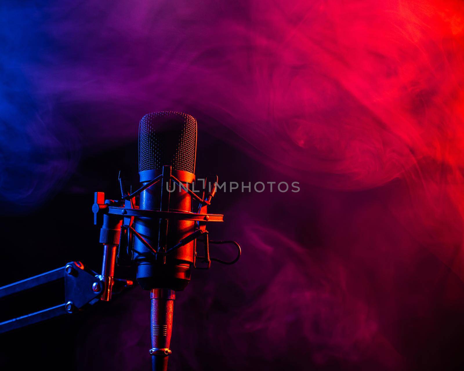 Professional microphone in pink smoke on a black background