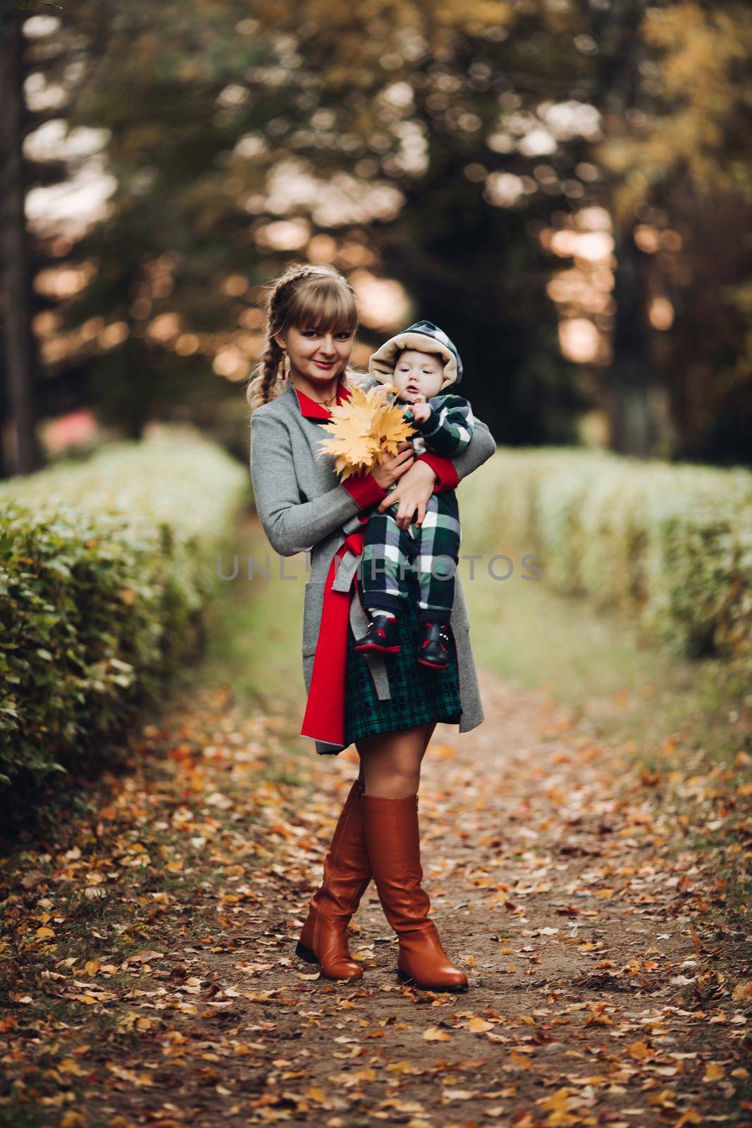 Beautiful caucasian mother with braid embracing her daughter. by StudioLucky