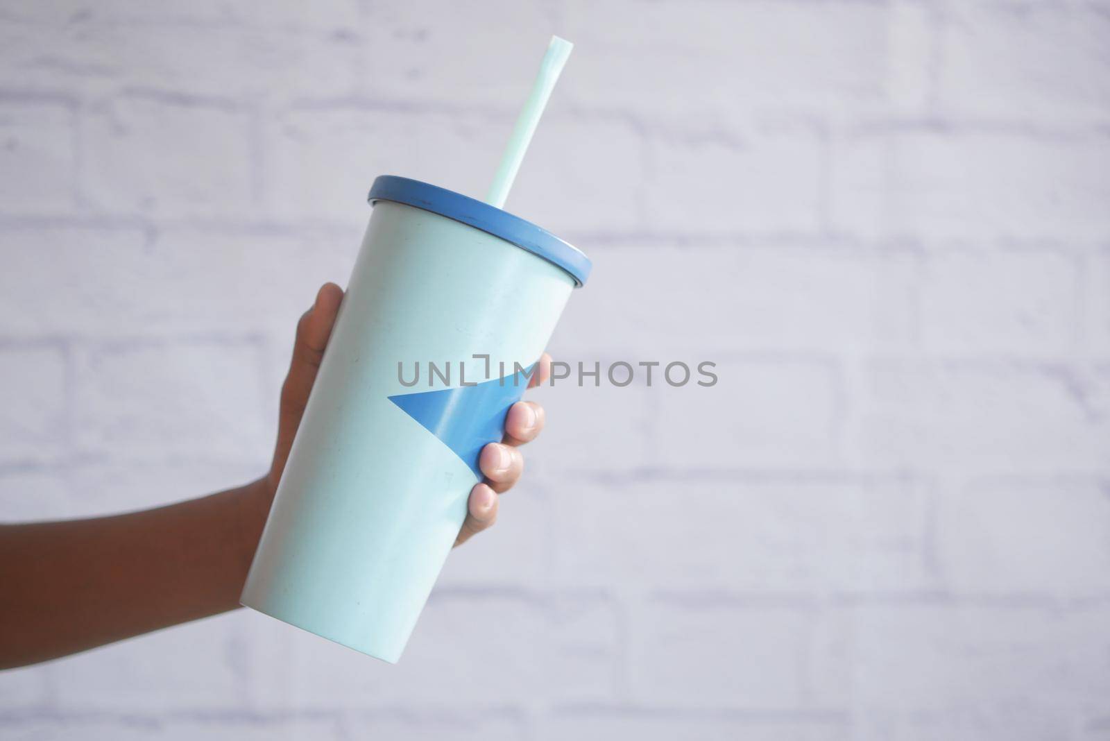 holding a reusable eco coffee cup with copy space