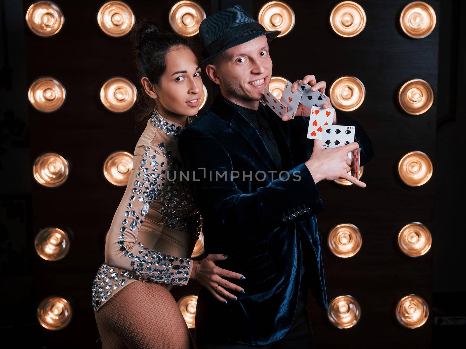 Passion in work and in love. Happy couple posing for the portrait. Family business of magician tricks and shows.