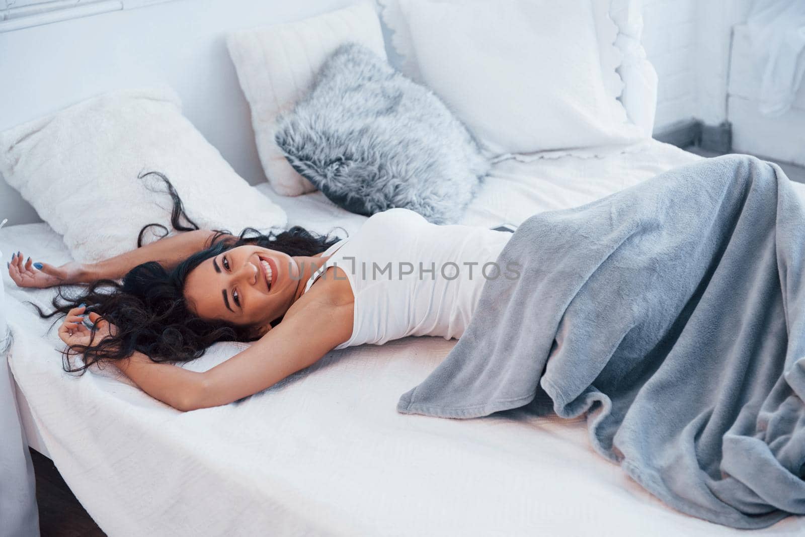 Girl have weekend lying in the bed. Brunette resting on the couch.