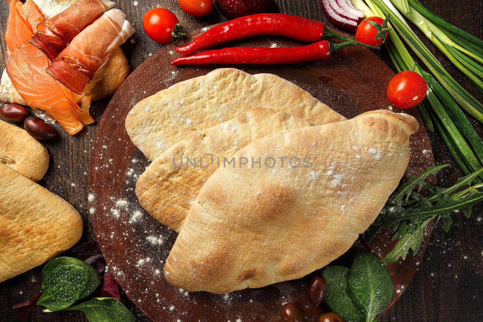 Doner kebab or pita on a wooden tray.