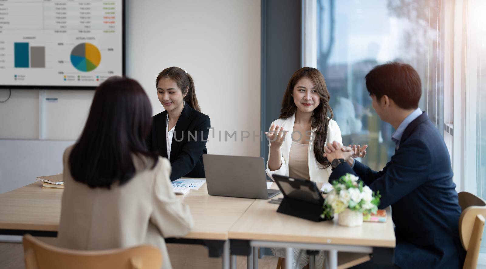 Group of young business asian people working and communicating at the office by nateemee