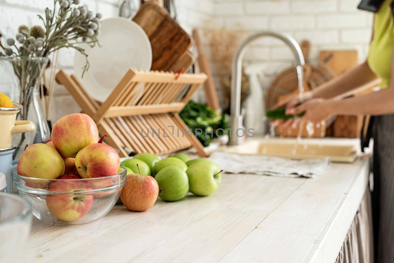 Preparing healthy foods. Healthy eating and dieting. Close up of table with green vegetables and fresh fruit in the kitchen