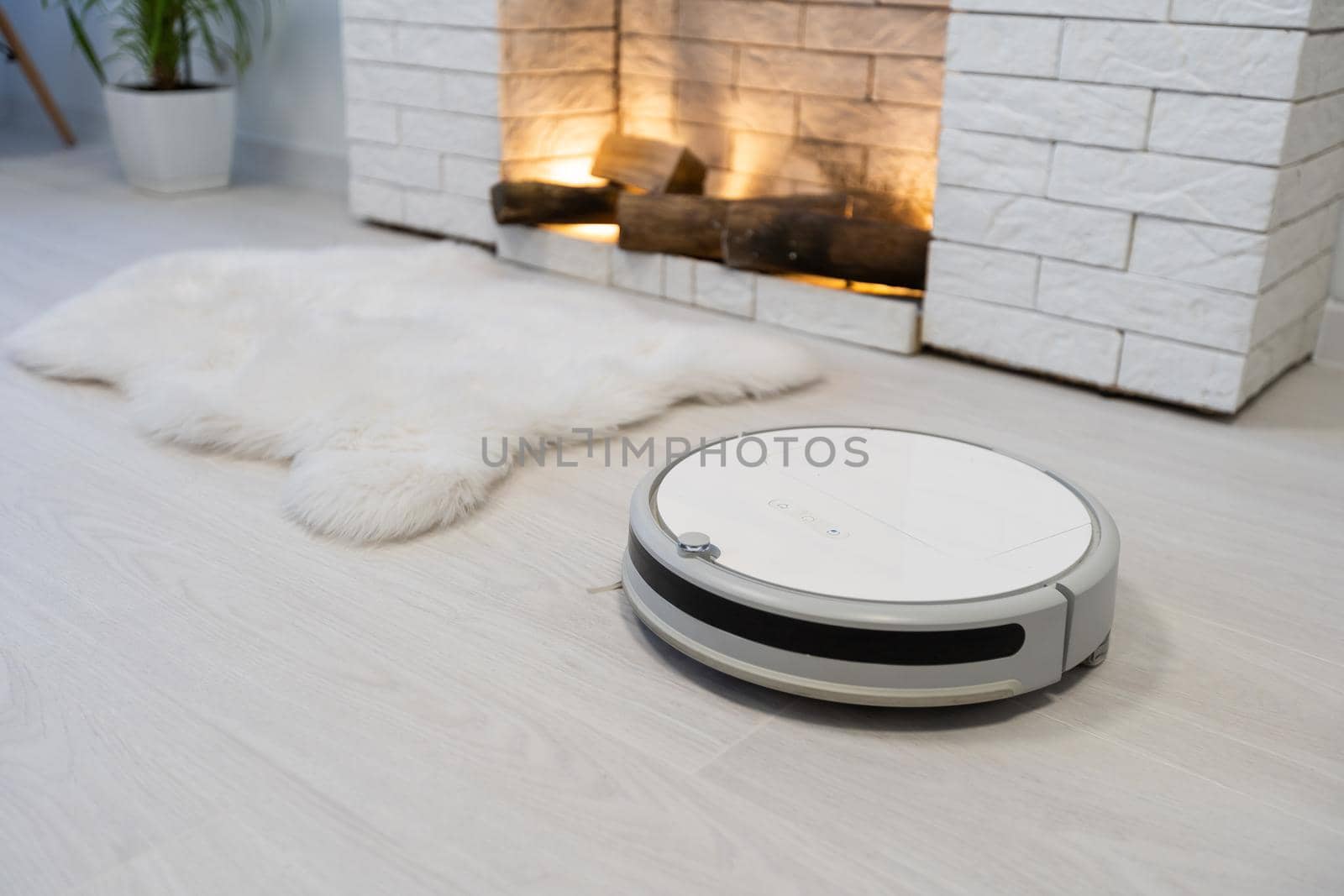robotic vacuum cleaner on laminate wood floor smart cleaning technology by Andelov13