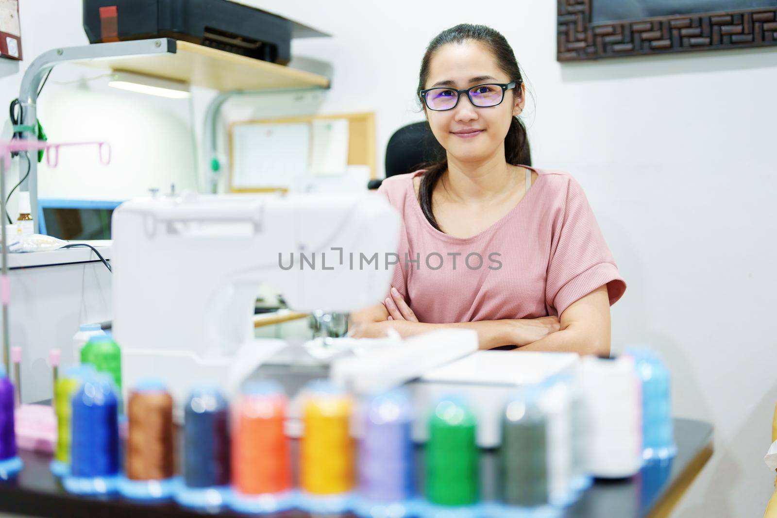 Embroidery, handicrafts, hobbies, SME business, family business, Portrait of Asian female designers are doing by designing patterns using automatic embroidery machines by customer order. by Manastrong