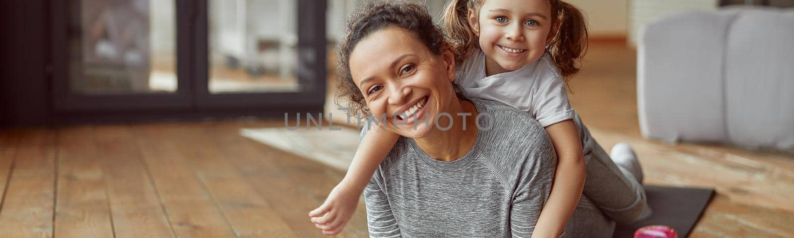 Happy mom and daughter spending active time indoors by Yaroslav_astakhov