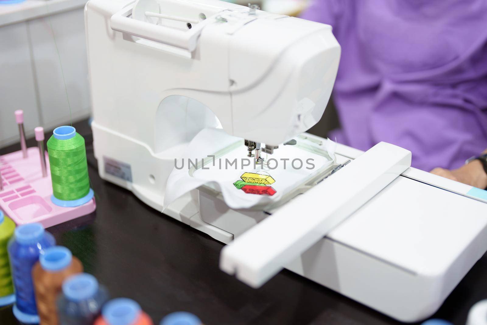 Embroidery, handicrafts, hobbies, SME business, family business, Portrait of Asian female designers are doing by designing patterns using automatic embroidery machines by customer order