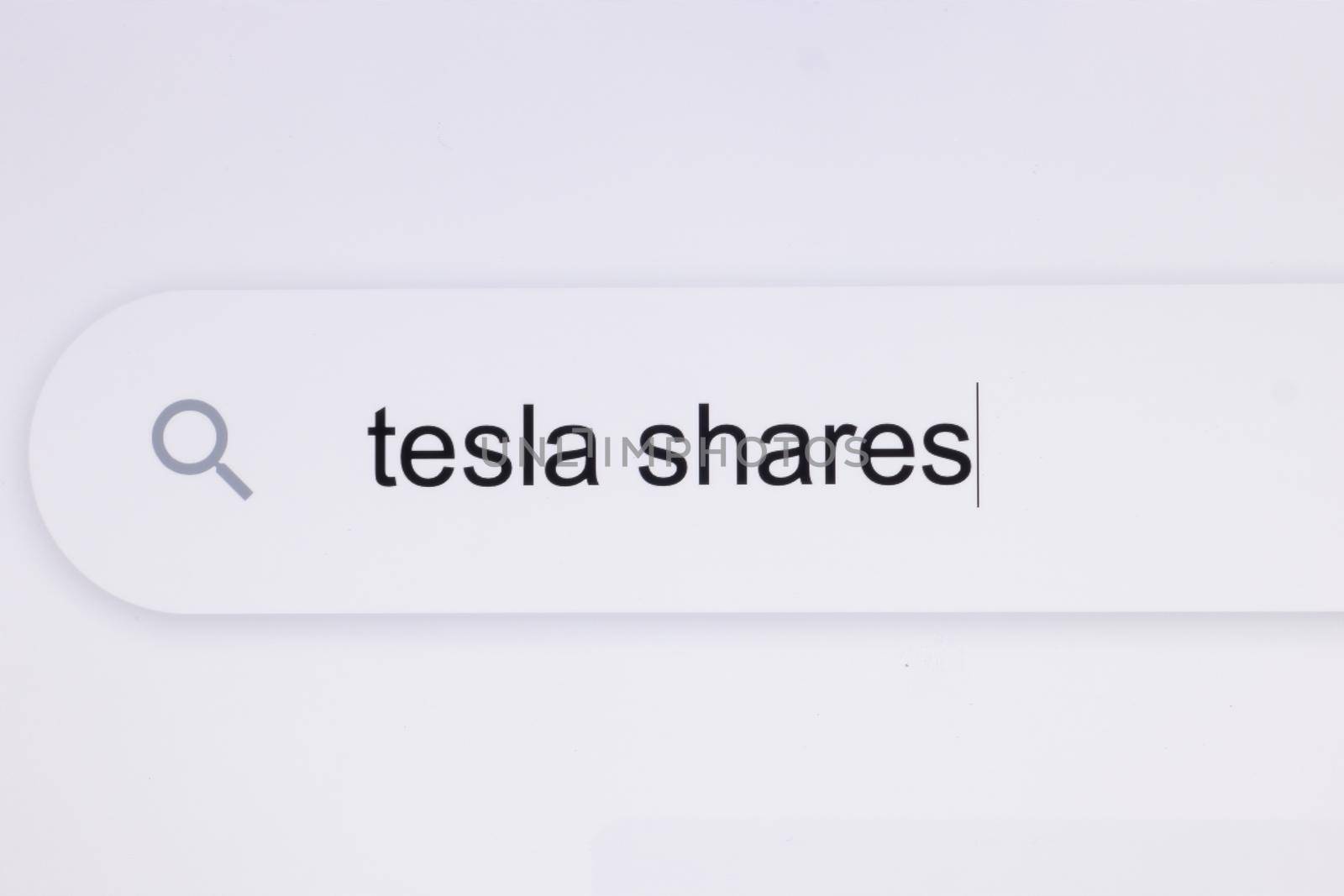 Typing the word Tesla shares in the browser on a pixelated screen. Searching For an Online Network Website. Searching The World Wide Web Internet on a Computer by uflypro