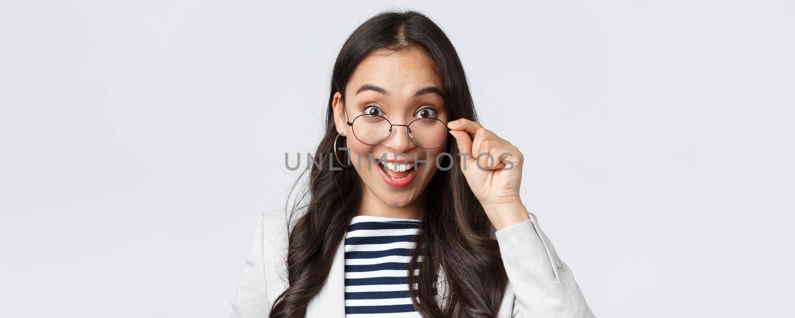 Business, finance and employment, female successful entrepreneurs concept. Excited happy asian office worker take-off glasses and smiling astonished as receive awesome deal by Benzoix