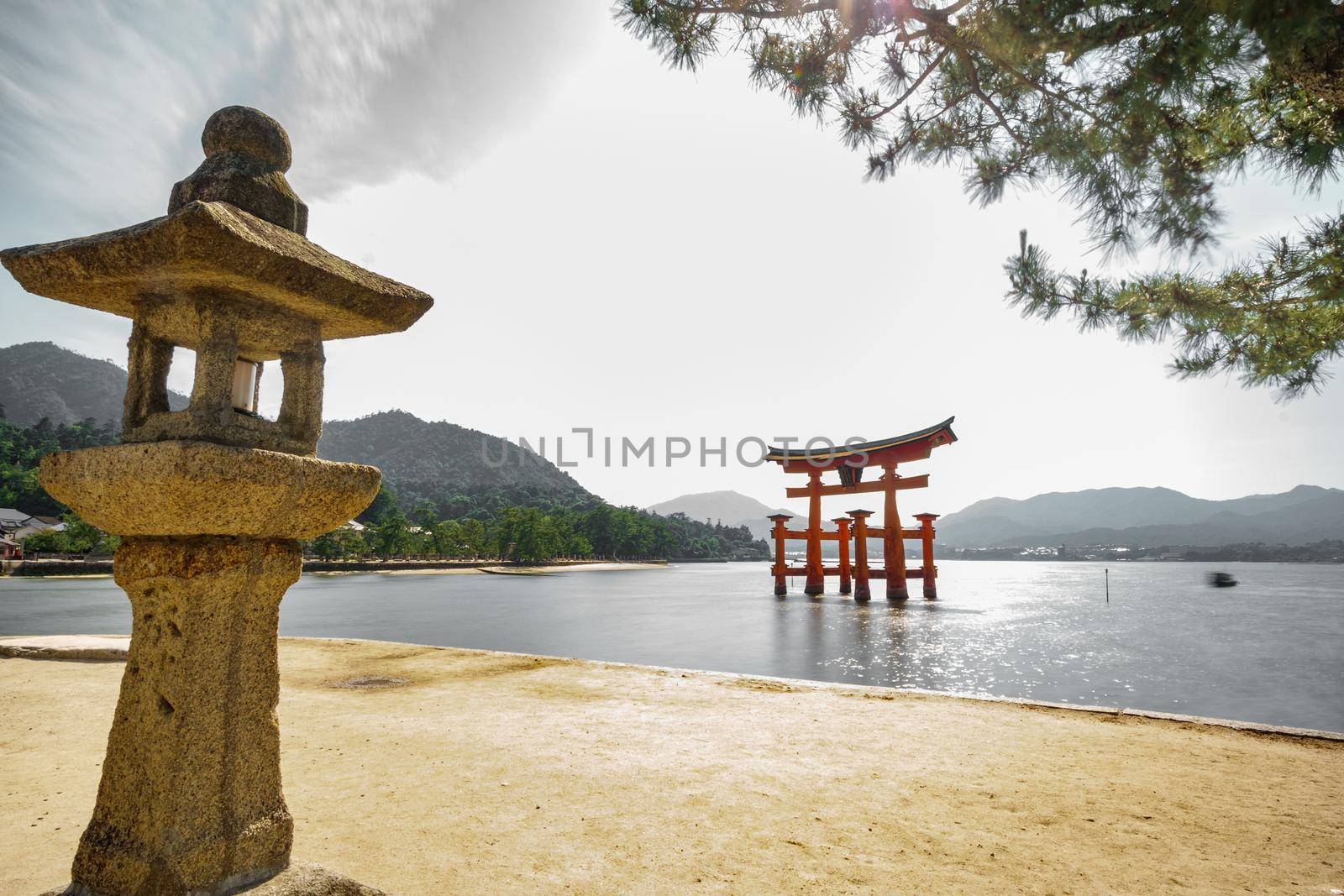 Miyajima with Floating Torii gate and stone lantern, high tide, Japan.
