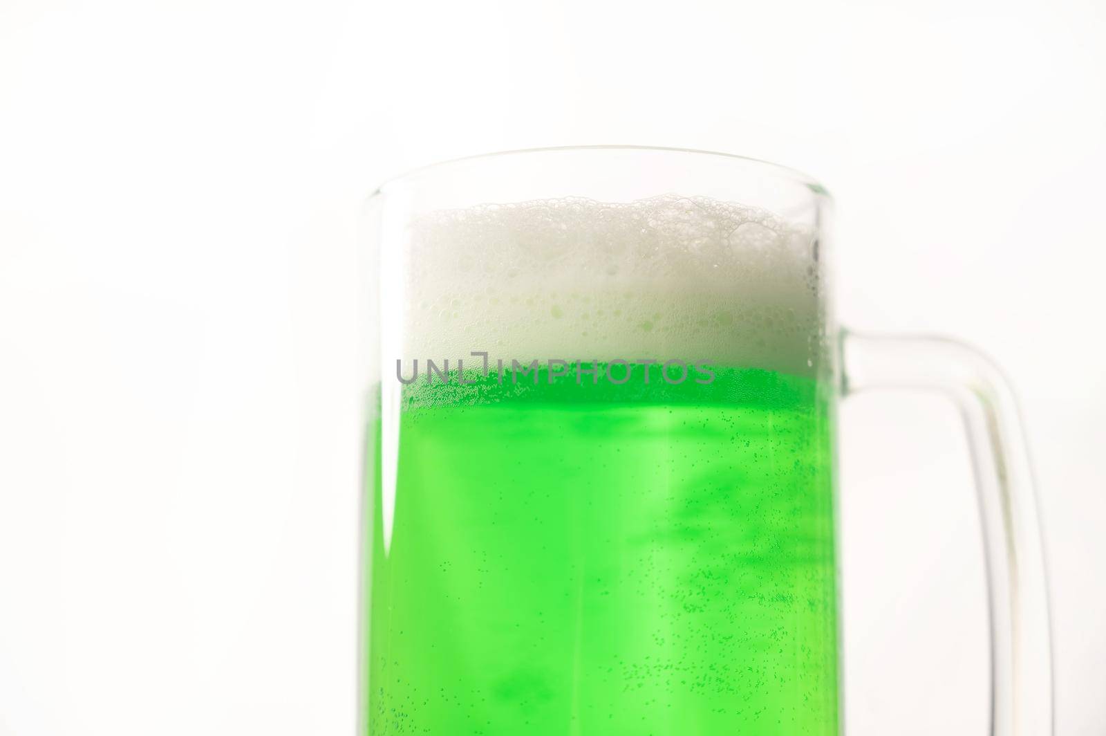 A pint of green beer for st patrick's day on a white background. Traditional Irish drink for a holiday by mrwed54