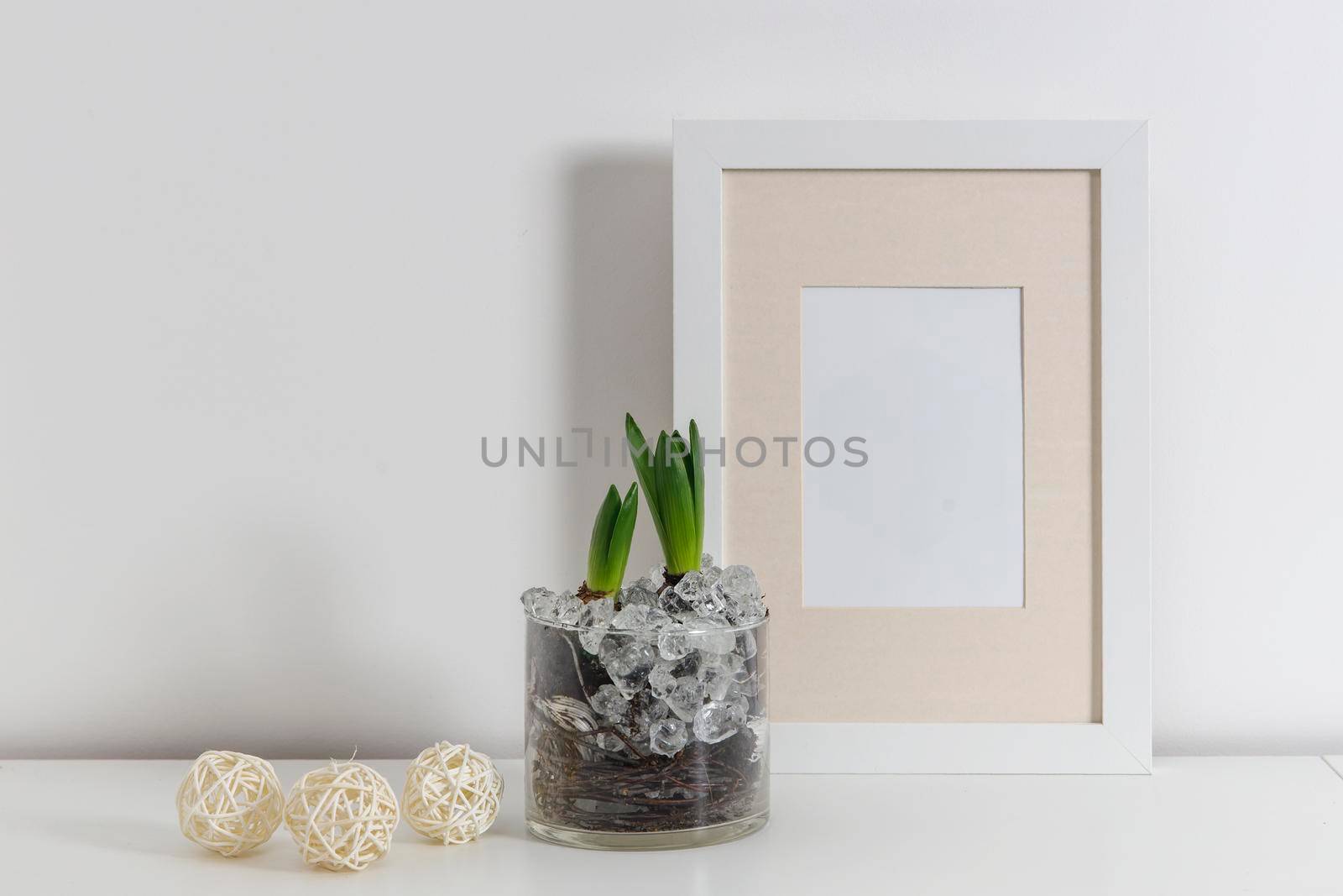 Blank canvas frame mockup. Artwork in interior design. View of modern scandinavian style interior with canvas for painting or poster on wall. Living room, commode with vases. Minimalism concept by elenarostunova