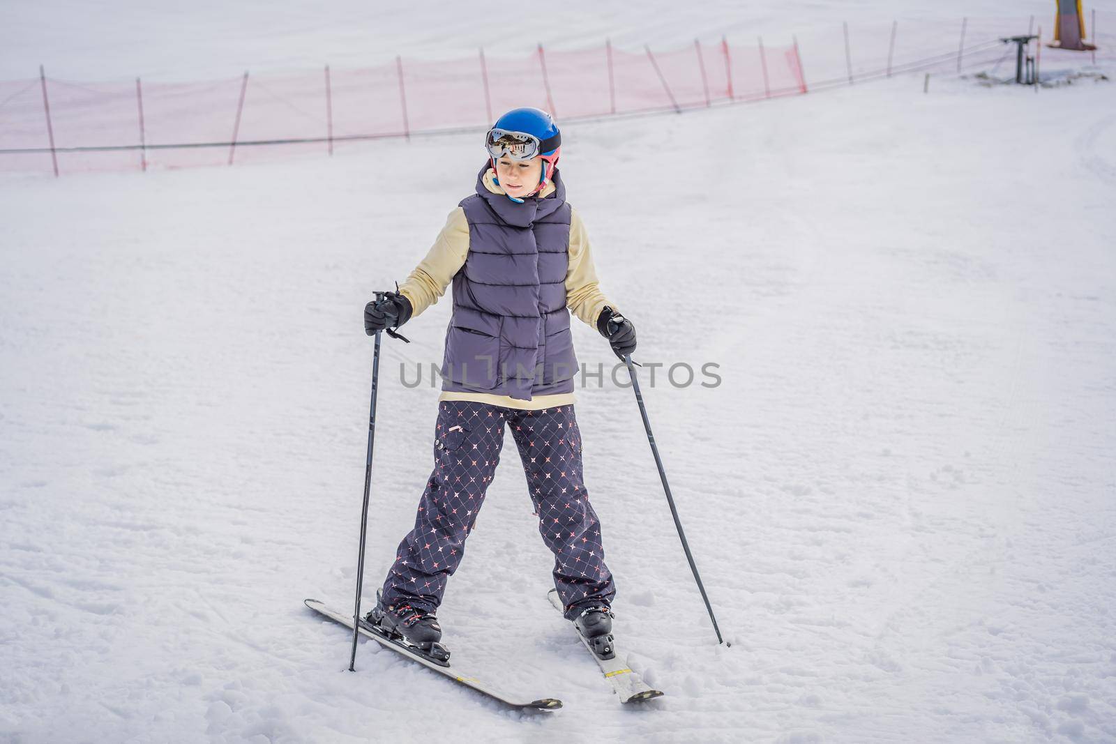 Woman learning to ski. Young woman skiing on a snowy road in the mountains.