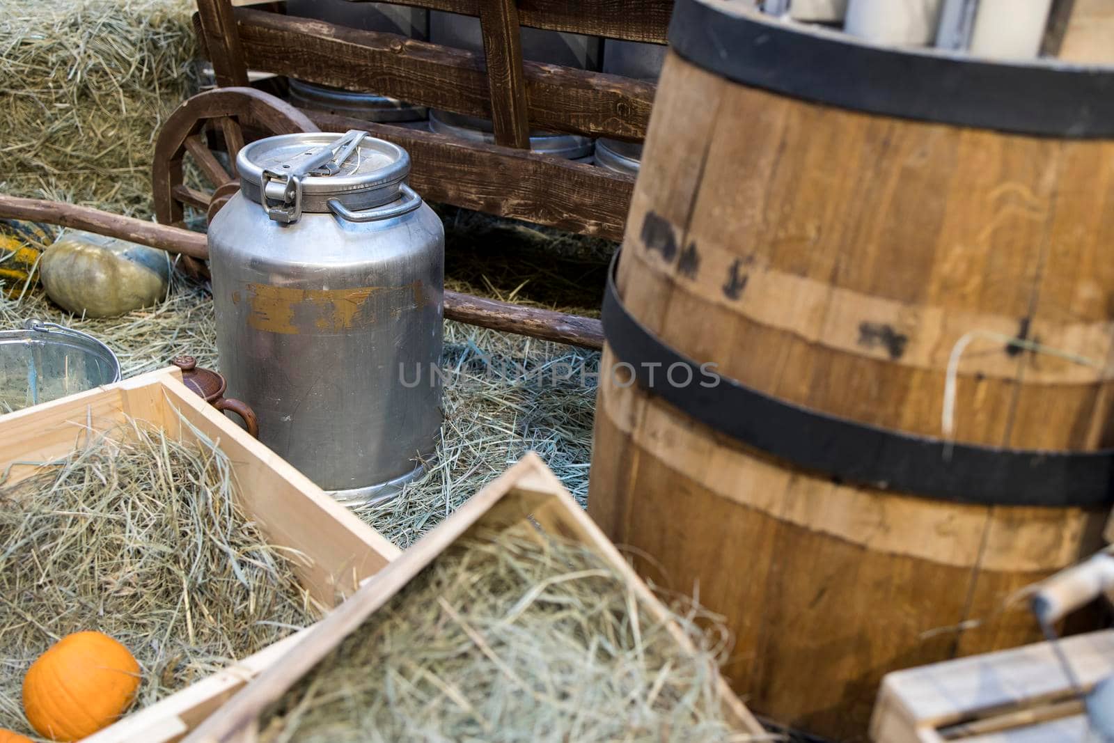 Milk - decoration on farm. Agriculture, farming. Farmer milk in bottles. Natural milk, organic milk. Vintage ornament with hay, straw and bottles with yogurt. Farmer product. Rustic decor. Products