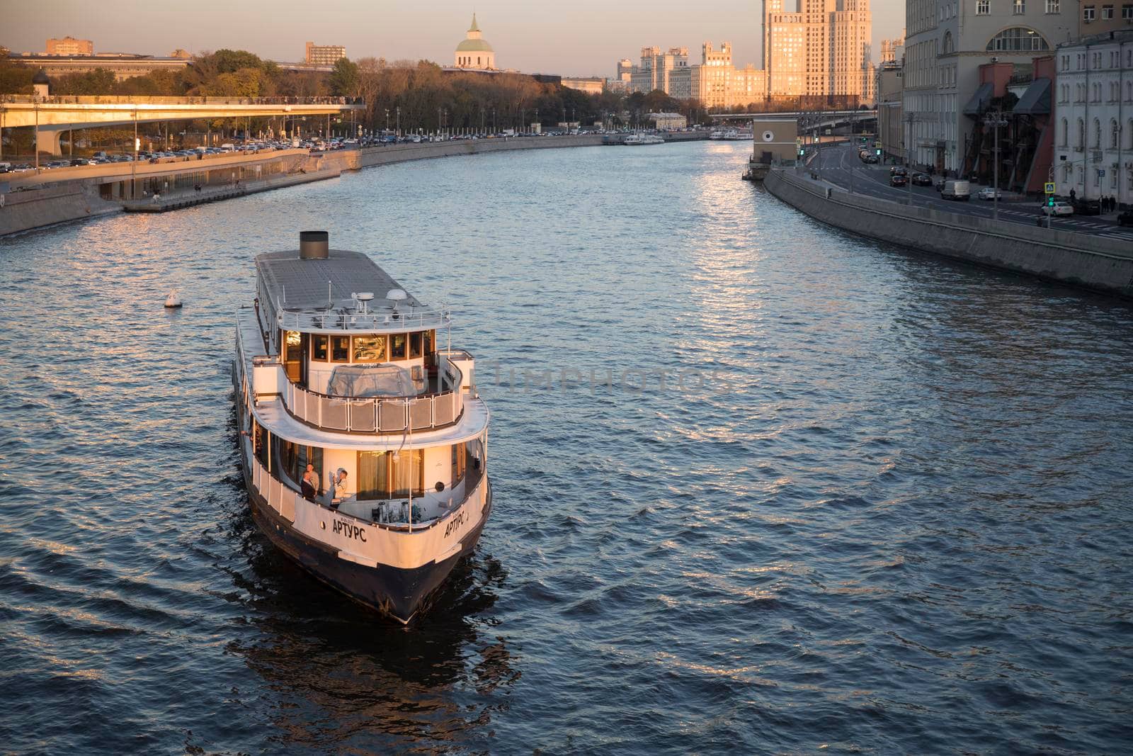 Russian scene: River trips on the Moscow river, view for the Vodootvodny canal in Moscow near Bolotnaya square at dusk by elenarostunova